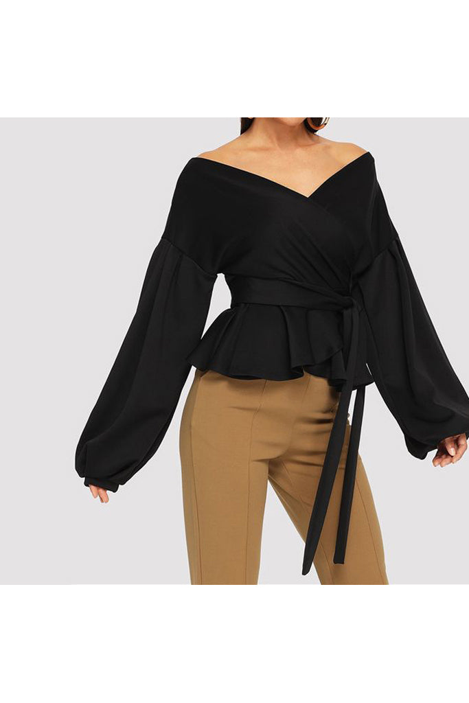 Model wearing puff sleeve asymmetrical top